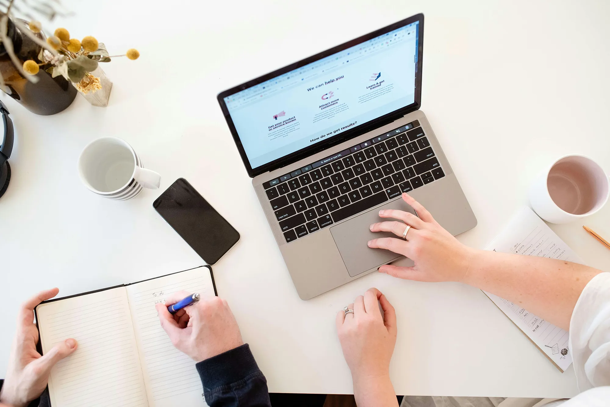 Newsletter advertising reach Desk with laptop displaying analytics.